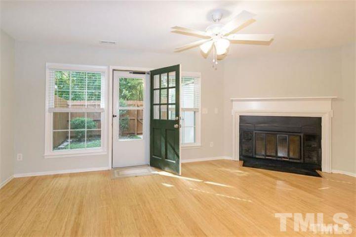 3148 Morningside Drive Raleigh, NC 27607 - Photo 3 of 24 a view of an empty room with a fireplace and a window