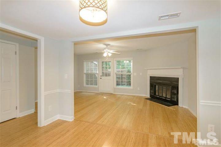 3148 Morningside Drive Raleigh, NC 27607 - Photo 5 of 24 a view of an empty room with a fireplace and a window