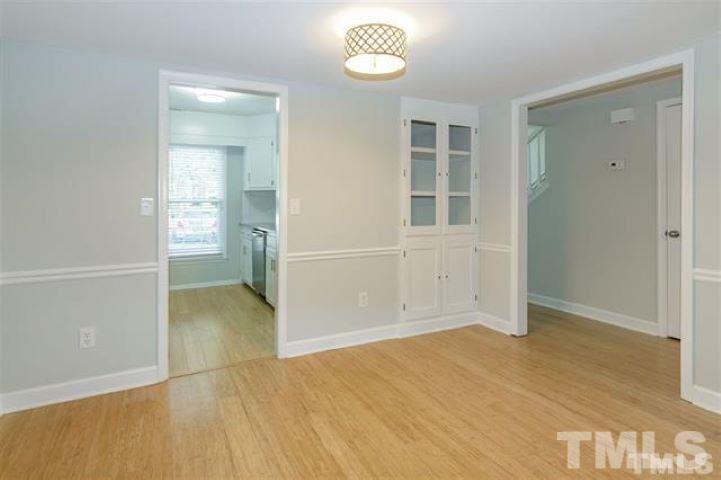 3148 Morningside Drive Raleigh, NC 27607 - Photo 6 of 24 an empty room with wooden floor and windows