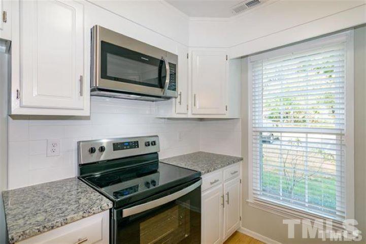 3148 Morningside Drive Raleigh, NC 27607 - Photo 9 of 24 a kitchen with stainless steel appliances granite countertop a stove microwave and sink