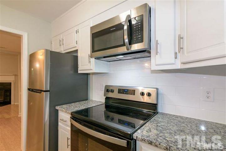 3148 Morningside Drive Raleigh, NC 27607 - Photo 10 of 24 a kitchen with stainless steel appliances a stove microwave and refrigerator
