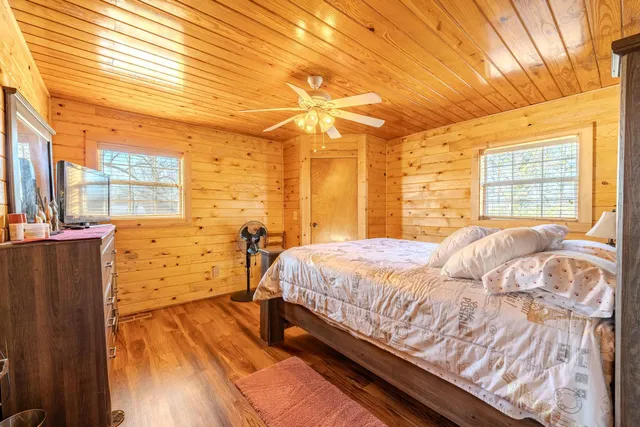 a bed sitting in a bedroom next to a window