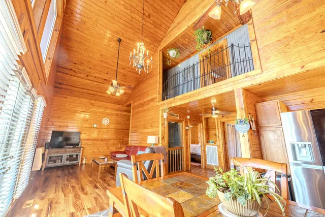 a view of a patio with couches table and chairs and potted plants