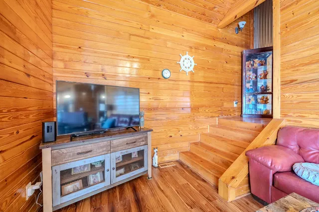 a view of a backyard with furniture and outdoor kitchen