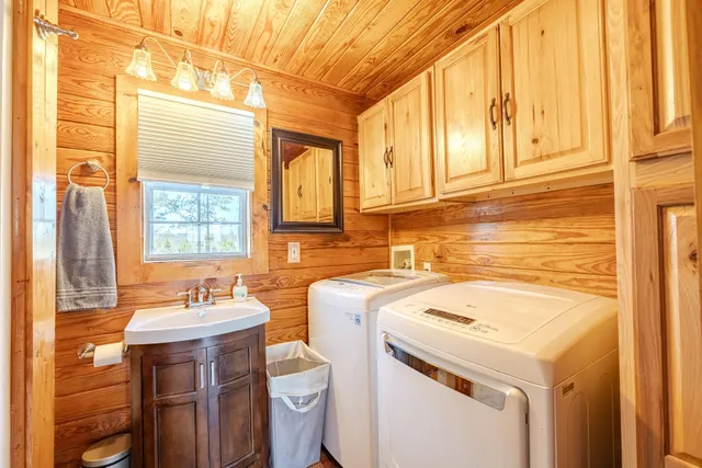 a bathroom with a sink and a washer dryer