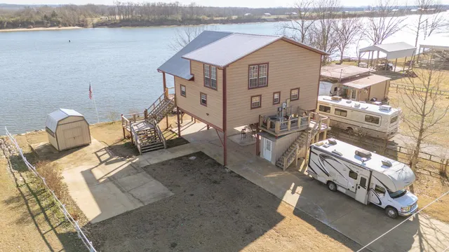 a view of a house with chairs and table