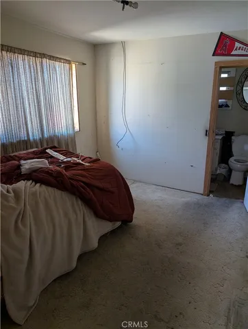 a bedroom with a bed and a mirror