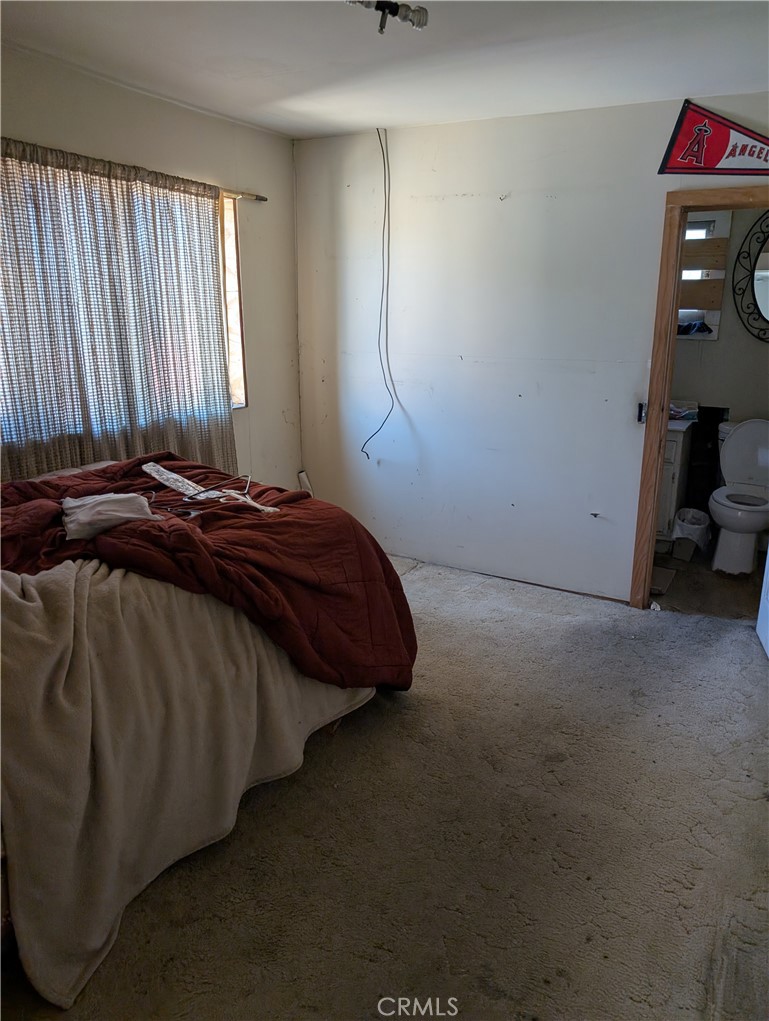 1071 Center Street Riverside, CA 92507 - Photo 17 of 24 a bedroom with a bed and a mirror