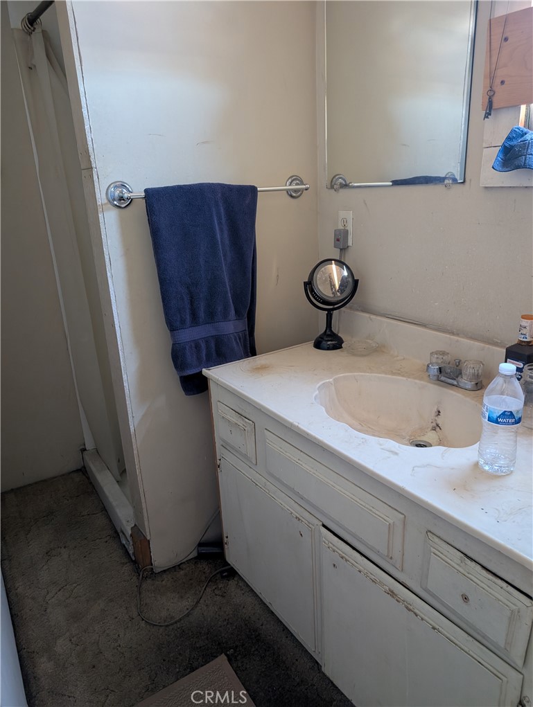 1071 Center Street Riverside, CA 92507 - Photo 21 of 24 a bathroom with a sink and a mirror