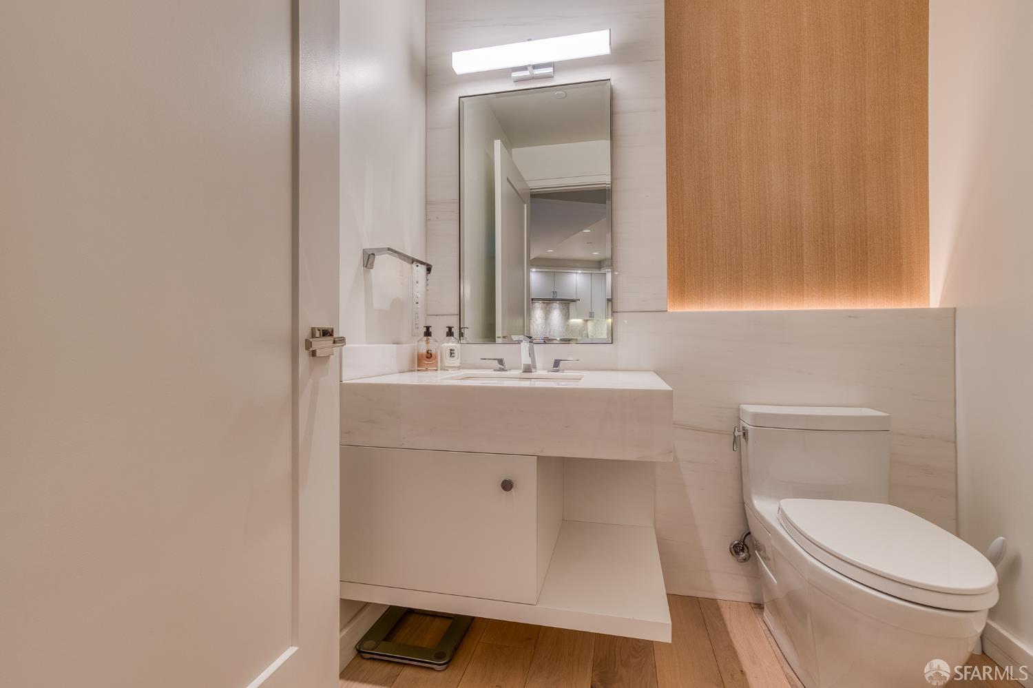 875 California Street, Unit 403 San Francisco, CA 94108 - Photo 31 of 56 a bathroom with a sink toilet and mirror