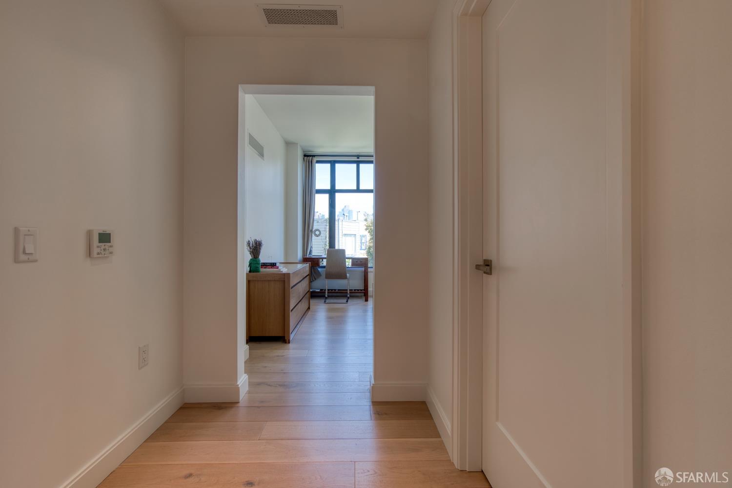 875 California Street, Unit 403 San Francisco, CA 94108 - Photo 47 of 56 a view of a hallway with wooden floor and a bathroom
