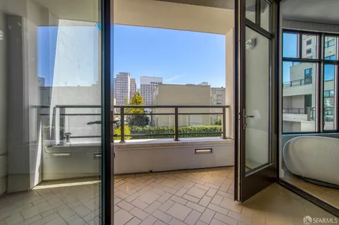 a room with a white bed and cabinets