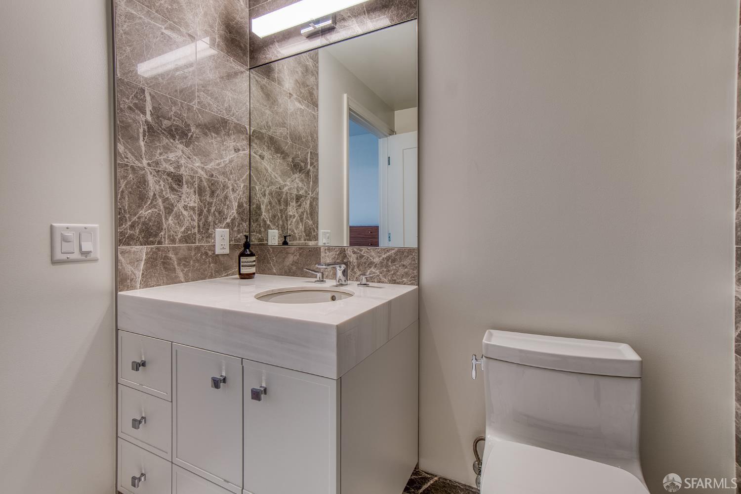 875 California Street, Unit 403 San Francisco, CA 94108 - Photo 52 of 56 a bathroom with a sink toilet and mirror