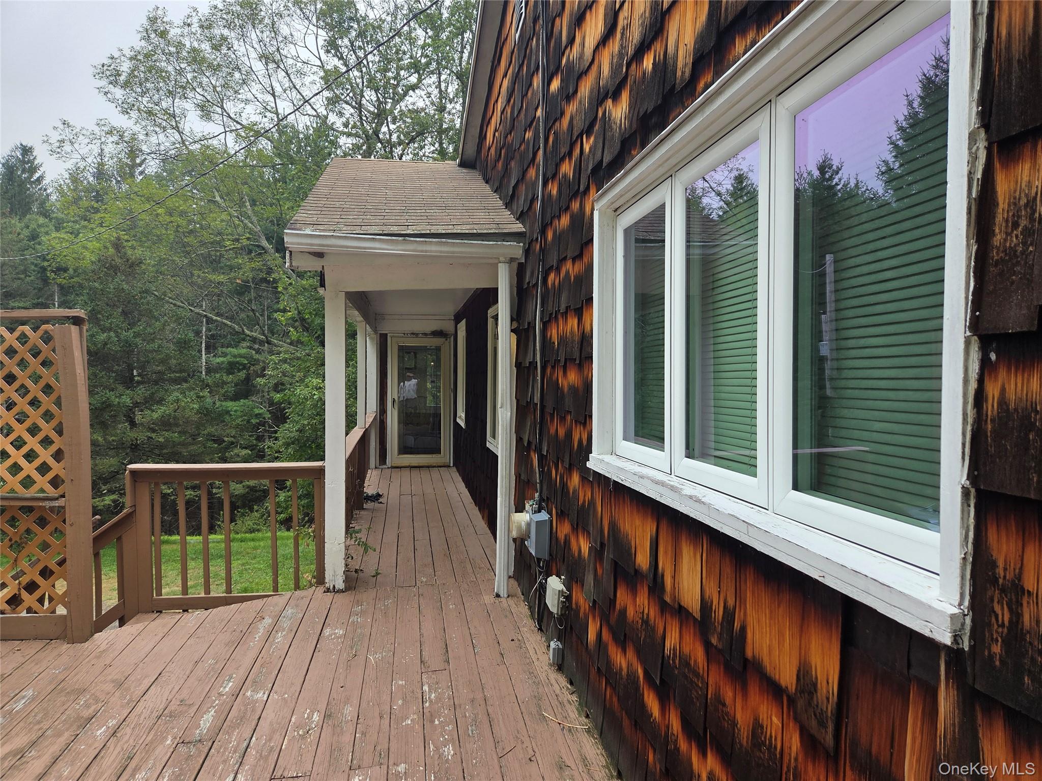 63 Otens Road Ellenville, NY 12428 - Photo 3 of 32 a view of backyard with deck and outdoor seating