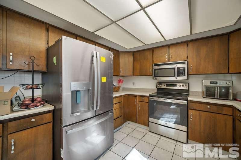2080 4th Street Sparks, NV 89431 - Photo 11 of 27 a kitchen with stainless steel appliances granite countertop a refrigerator stove and sink
