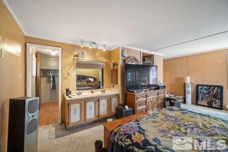 2080 4th Street Sparks, NV 89431 - Photo 14 of 27 a bedroom with a bed and a flat screen tv