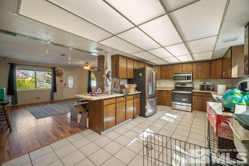2080 4th Street Sparks, NV 89431 - Photo 9 of 27 a large kitchen with stainless steel appliances granite countertop a stove and cabinets