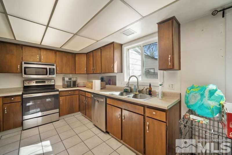 2080 4th Street Sparks, NV 89431 - Photo 10 of 27 a kitchen with stainless steel appliances granite countertop a sink window and cabinets