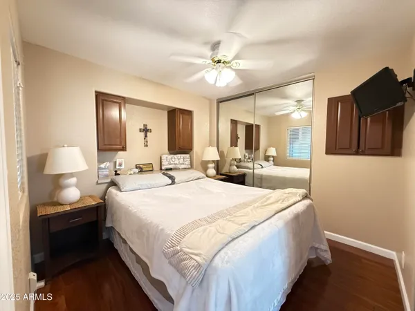 a spacious bedroom with a bed and a mirror