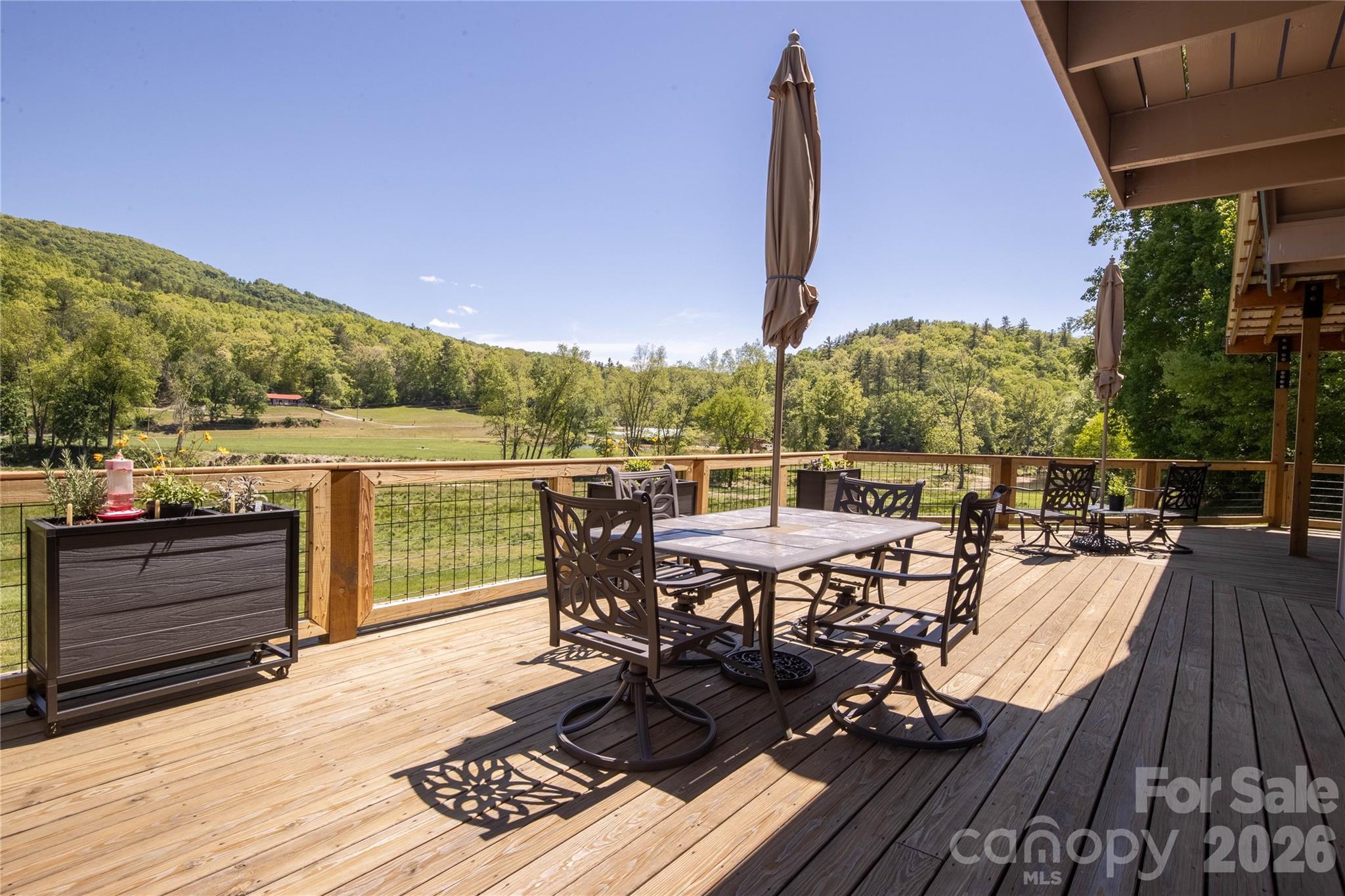 93 Franklin Crest Road Spruce Pine, NC 28777 - Photo 26 of 47 a view of a terrace with wooden floor and outdoor seating