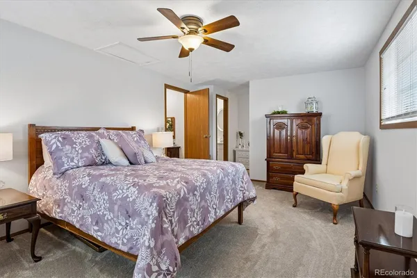 a spacious bedroom with a bed and a chandelier
