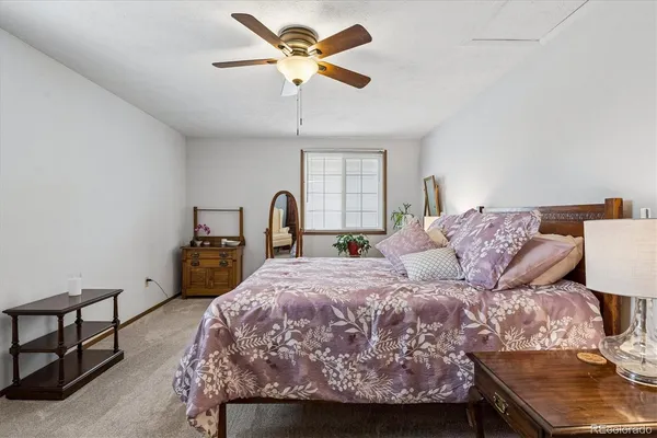a bedroom with a bed and a dresser with the potted plant