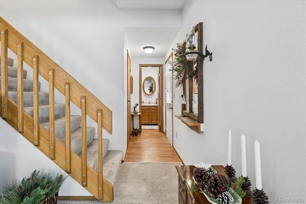 a view of a hallway with wooden floor and staircase