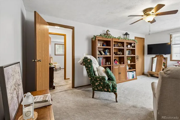 a view of a livingroom with furniture and a bookshelf