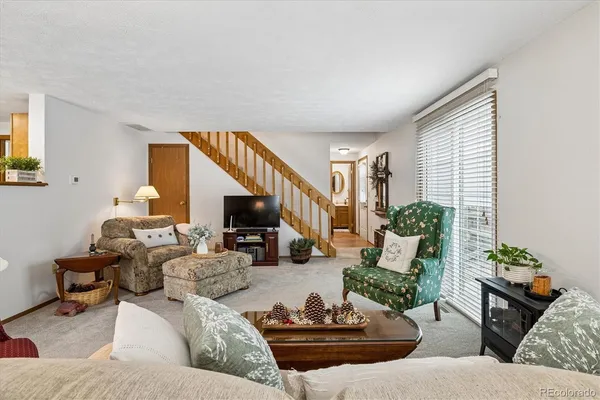 a living room with furniture and a potted plant