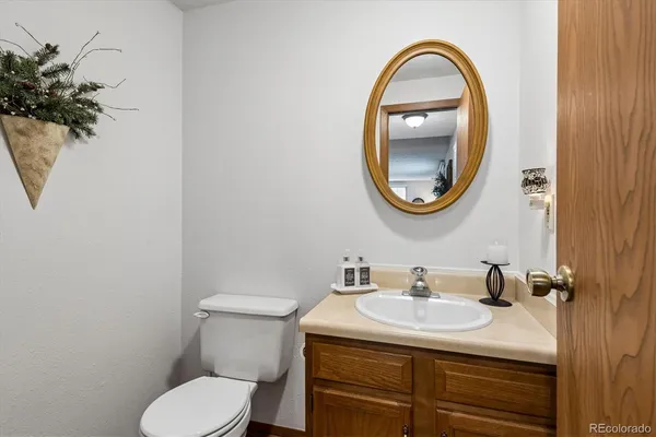 a bathroom with a sink toilet and a mirror