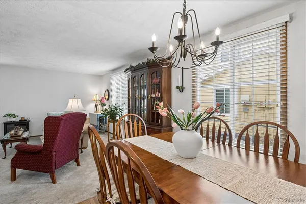 a view of a dining room and furniture a chandelier and wooden floor