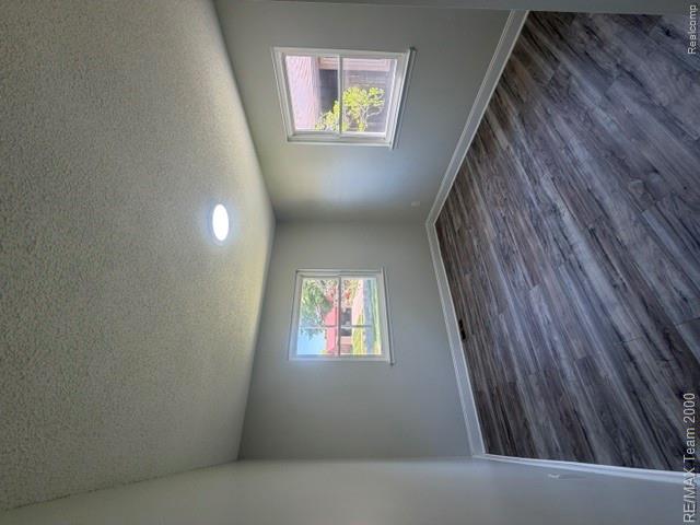 580 Palmerston Street River Rouge, MI 48218 - Photo 12 of 19 Neutral-toned room featuring wood-finish plank flooring, light gray wall paint, and white trim