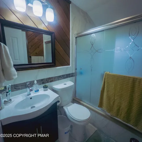 a bathroom with a sink a toilet and mirror