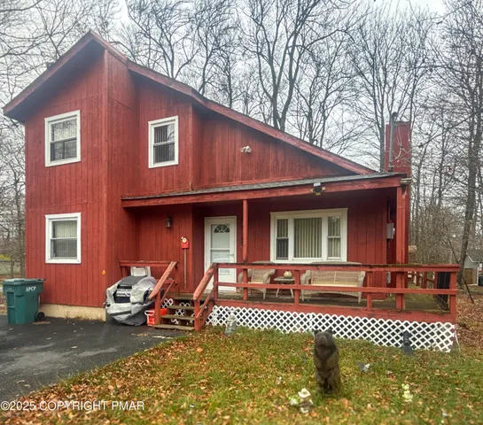 a front view of a house with glass top table and chairs