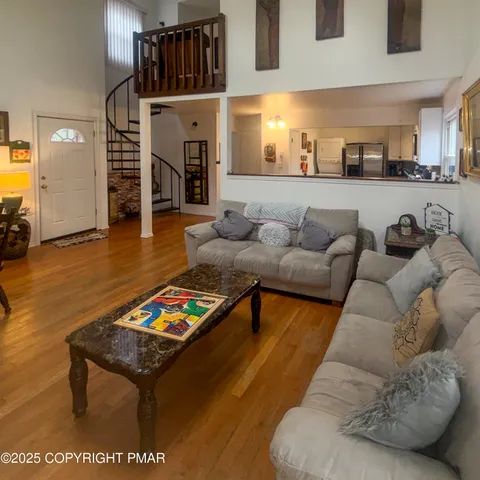 a living room with furniture and wooden floor