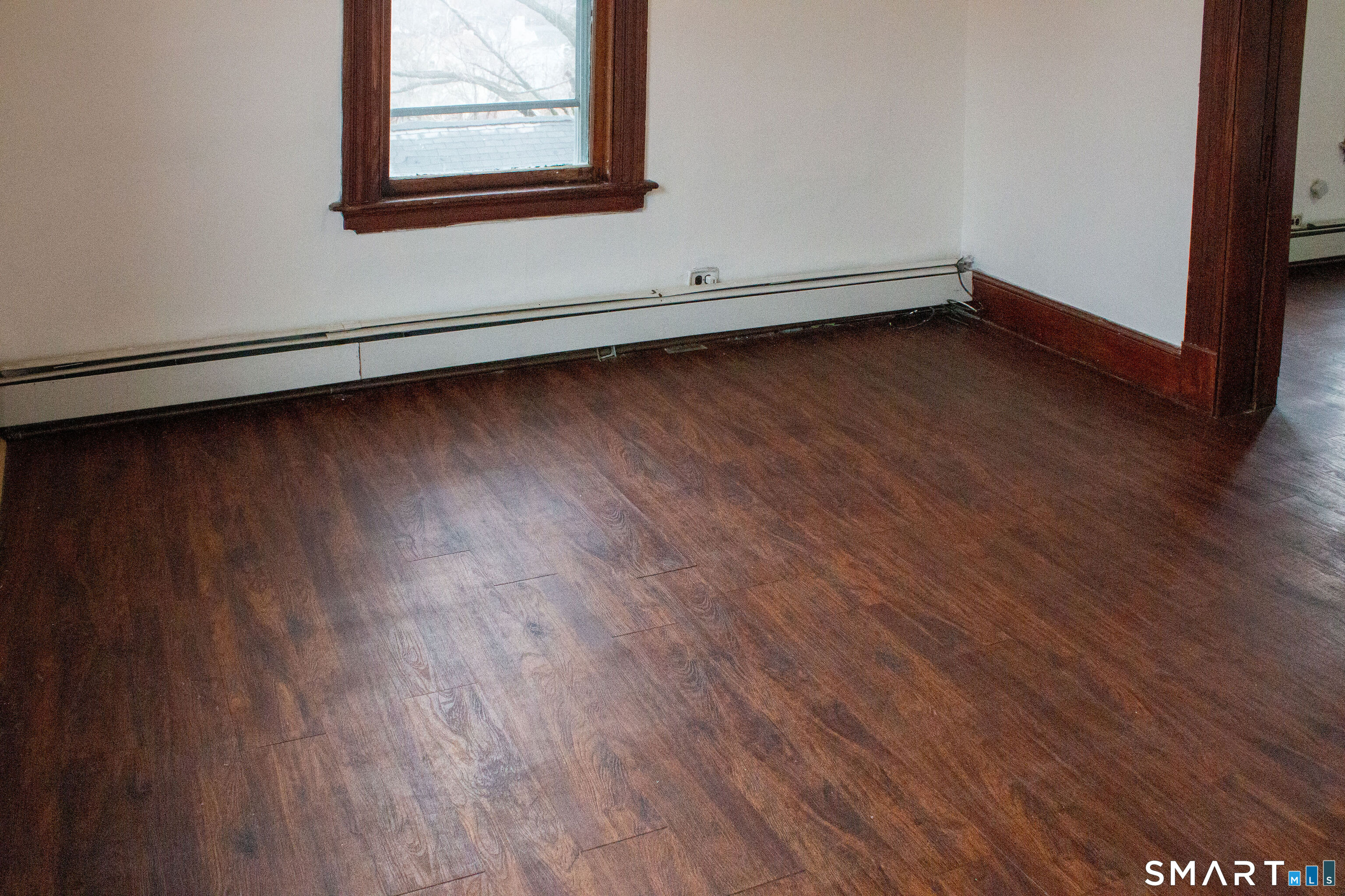 405 Wilson Street, Unit 3 Waterbury, CT 06708 - Photo 3 of 7 a view of a room with wooden floor and white walls