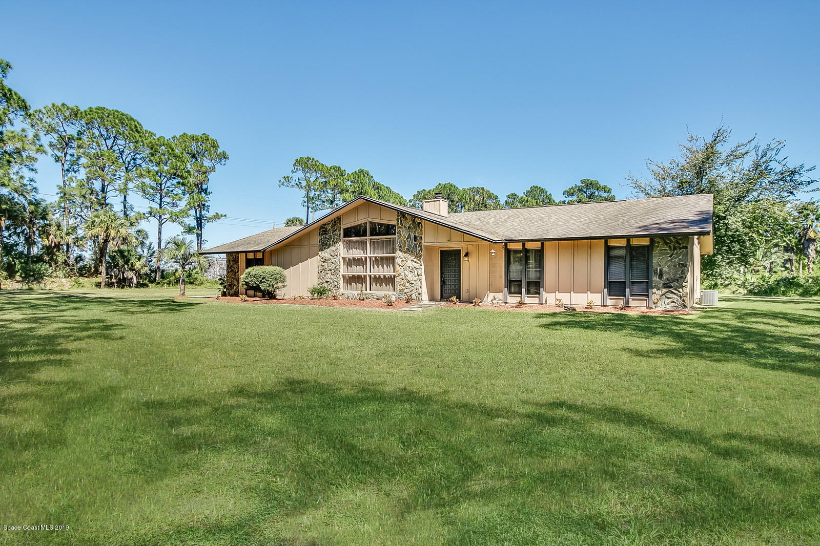 1695 Emmaus Road Northwest Palm Bay, FL 32907 - Photo 1 of 30 a front view of a house with a yard