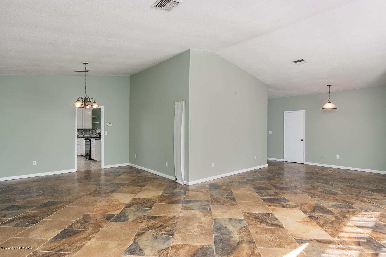 1695 Emmaus Road Northwest Palm Bay, FL 32907 - Photo 2 of 30 a view of a kitchen with a refrigerator and a cabinets