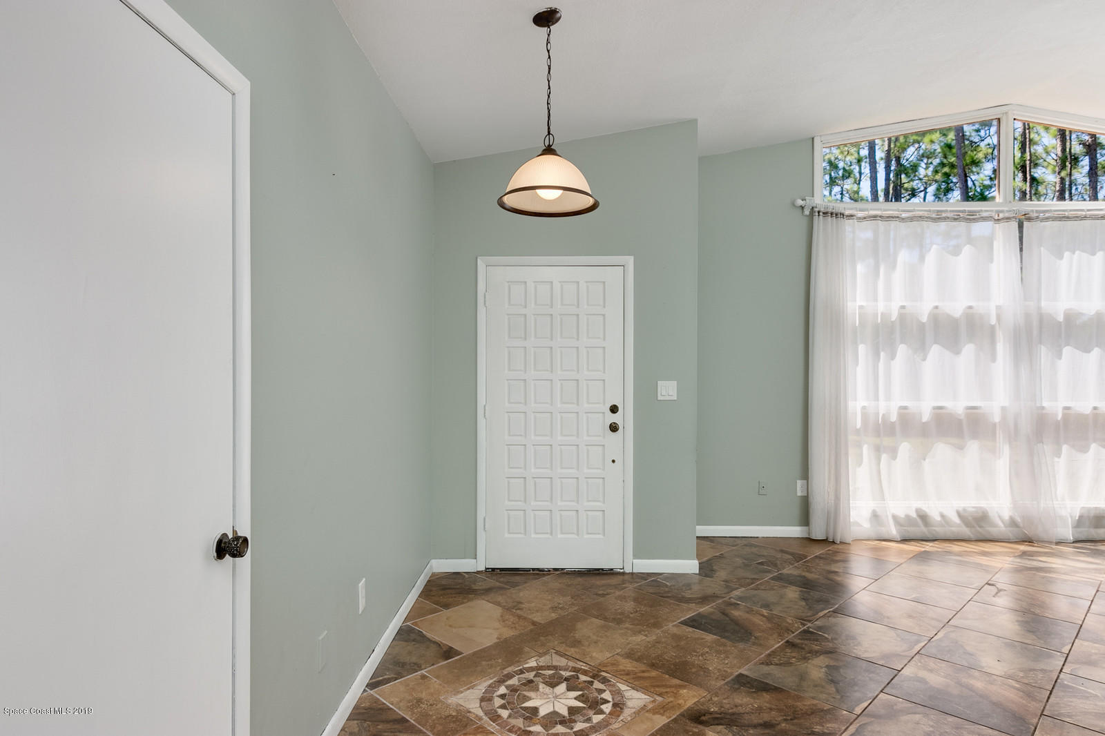 1695 Emmaus Road Northwest Palm Bay, FL 32907 - Photo 12 of 30 a view of a room with a window and wooden floor