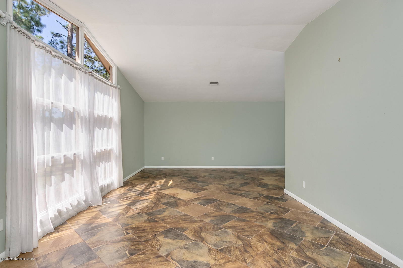 1695 Emmaus Road Northwest Palm Bay, FL 32907 - Photo 13 of 30 a view of an empty room with a window