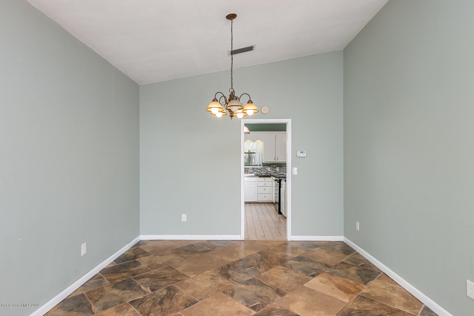 1695 Emmaus Road Northwest Palm Bay, FL 32907 - Photo 15 of 30 a view of a room with a chandelier fan and refrigerator