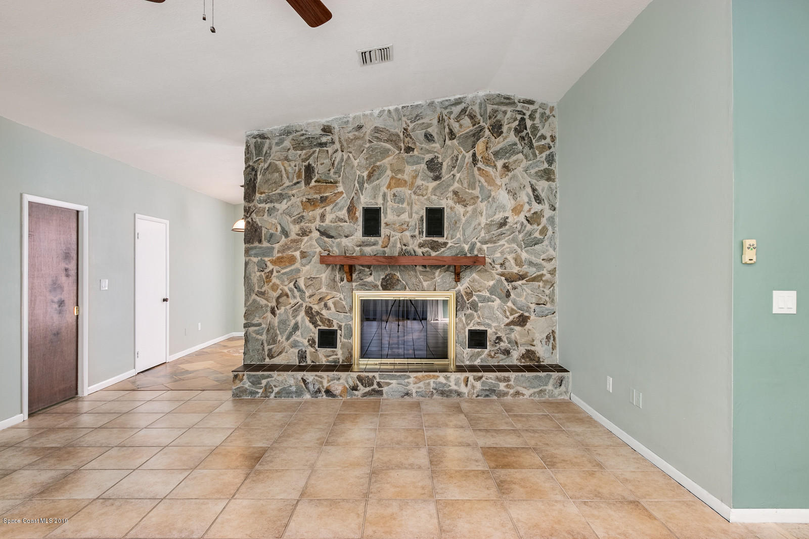 1695 Emmaus Road Northwest Palm Bay, FL 32907 - Photo 16 of 30 a living room with a fireplace