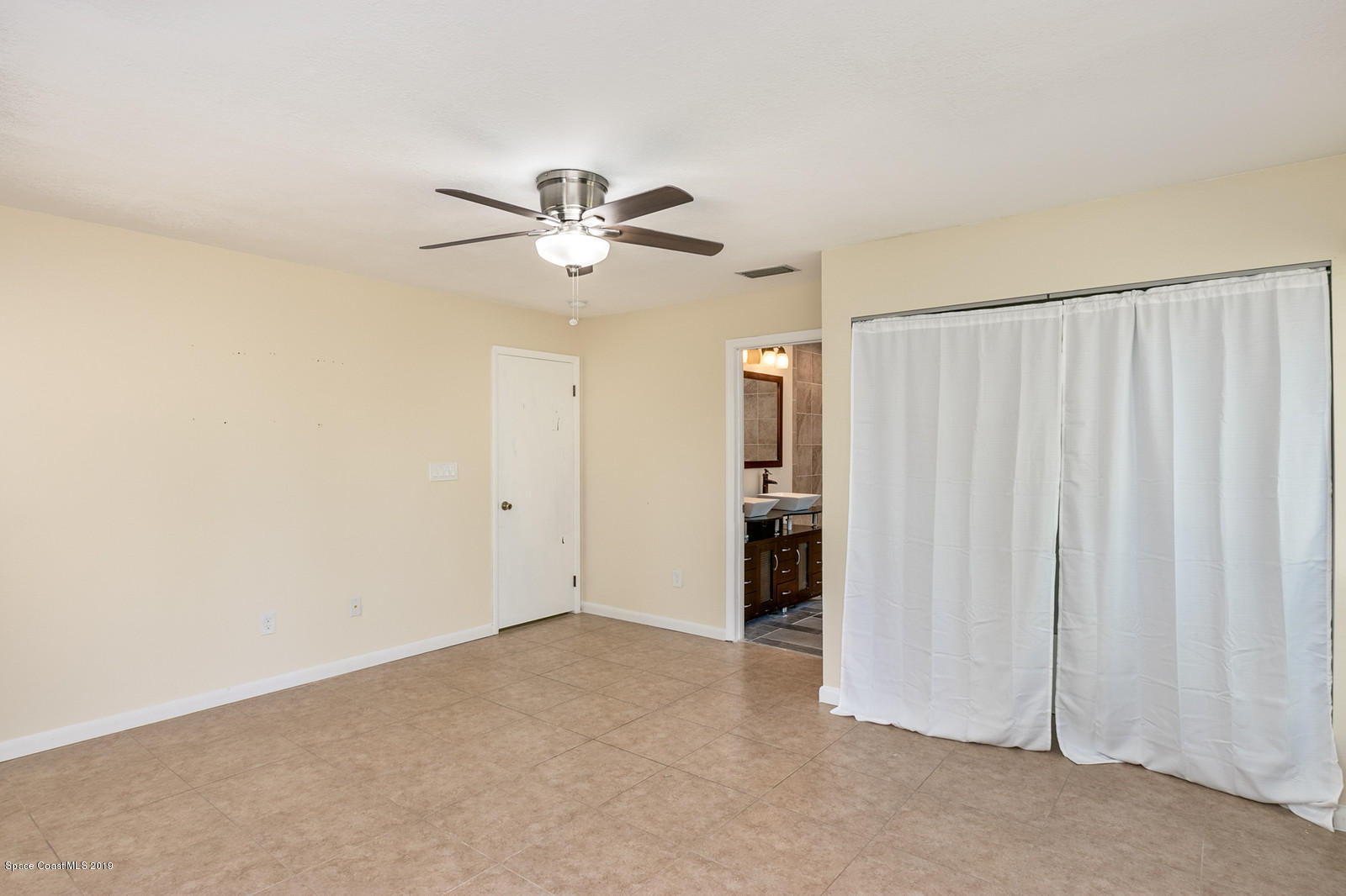 1695 Emmaus Road Northwest Palm Bay, FL 32907 - Photo 20 of 30 a view of a livingroom with a chandelier fan