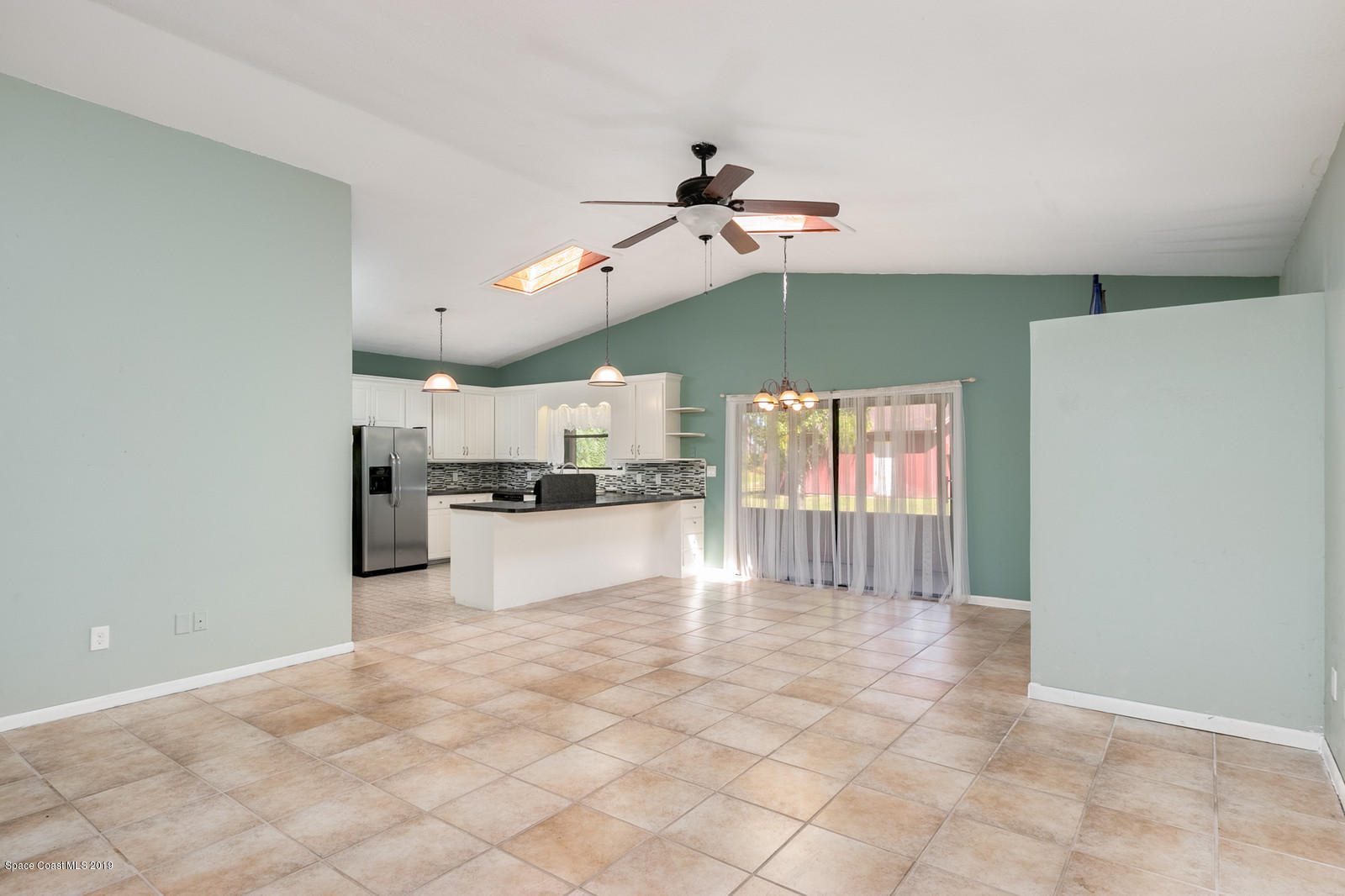 1695 Emmaus Road Northwest Palm Bay, FL 32907 - Photo 3 of 30 a view of a kitchen with a refrigerator and a window