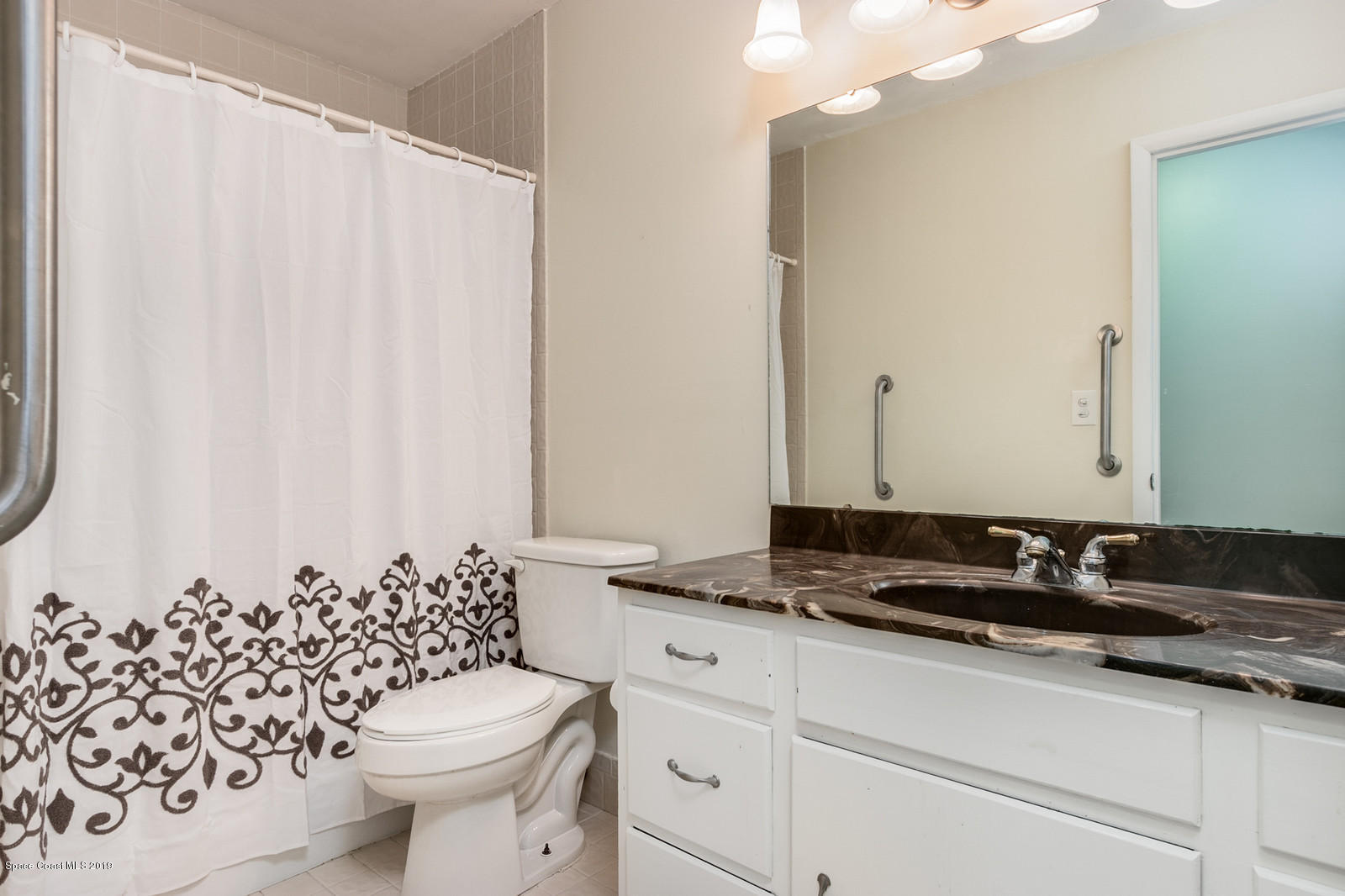 1695 Emmaus Road Northwest Palm Bay, FL 32907 - Photo 21 of 30 a bathroom with a granite countertop sink and a toilet