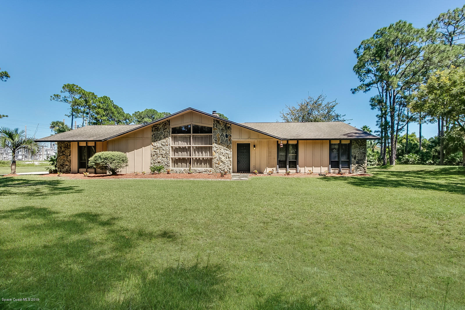1695 Emmaus Road Northwest Palm Bay, FL 32907 - Photo 25 of 30 a front view of a house with a garden