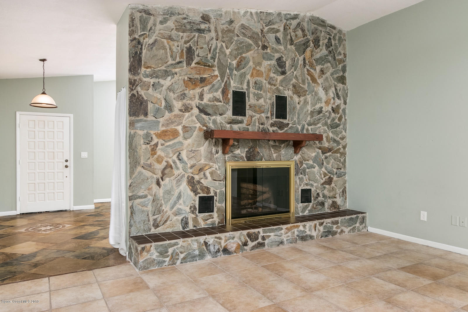 1695 Emmaus Road Northwest Palm Bay, FL 32907 - Photo 4 of 30 an empty room with a fireplace