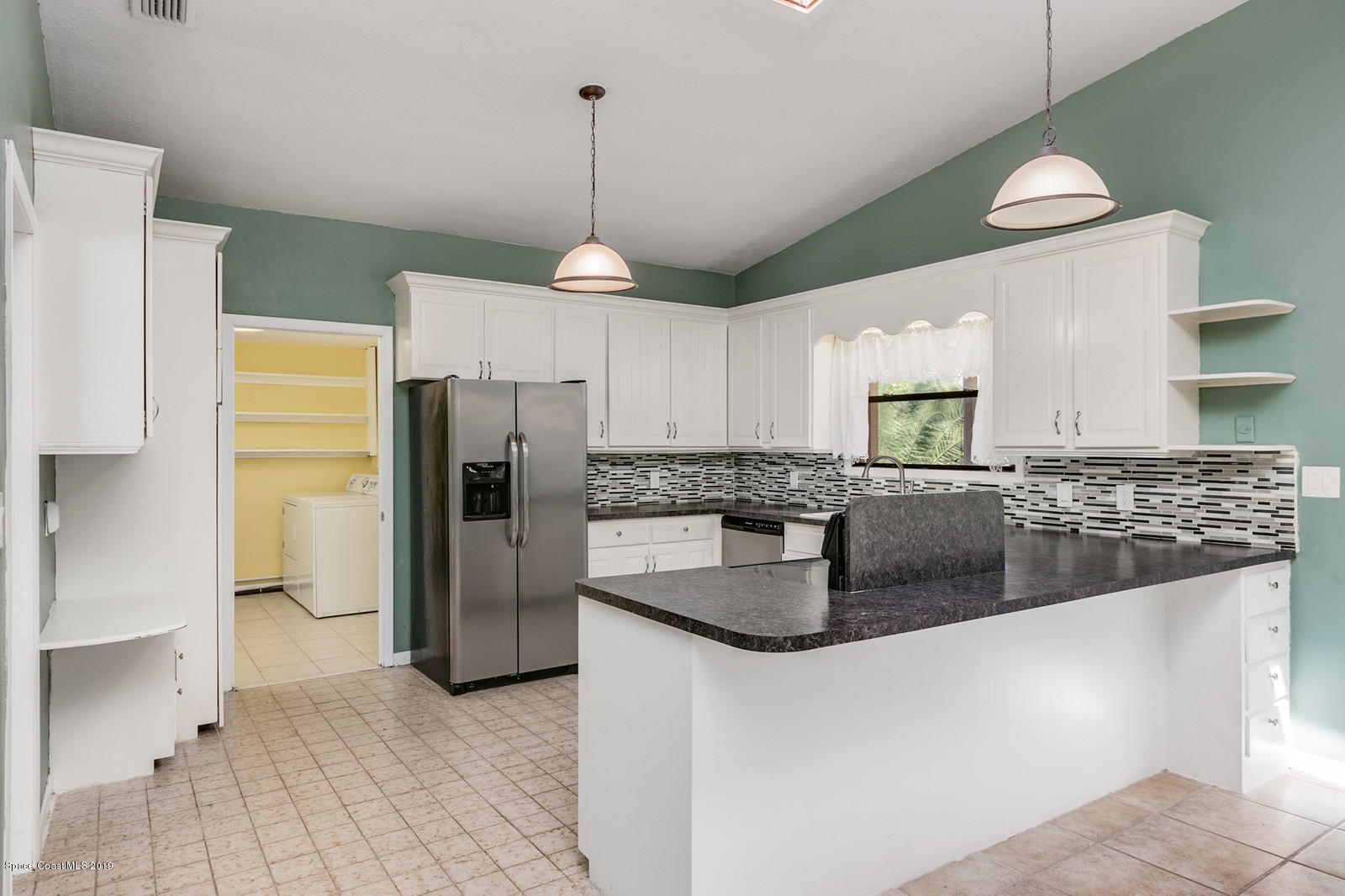 1695 Emmaus Road Northwest Palm Bay, FL 32907 - Photo 5 of 30 a kitchen with stainless steel appliances granite countertop a refrigerator a stove and a sink
