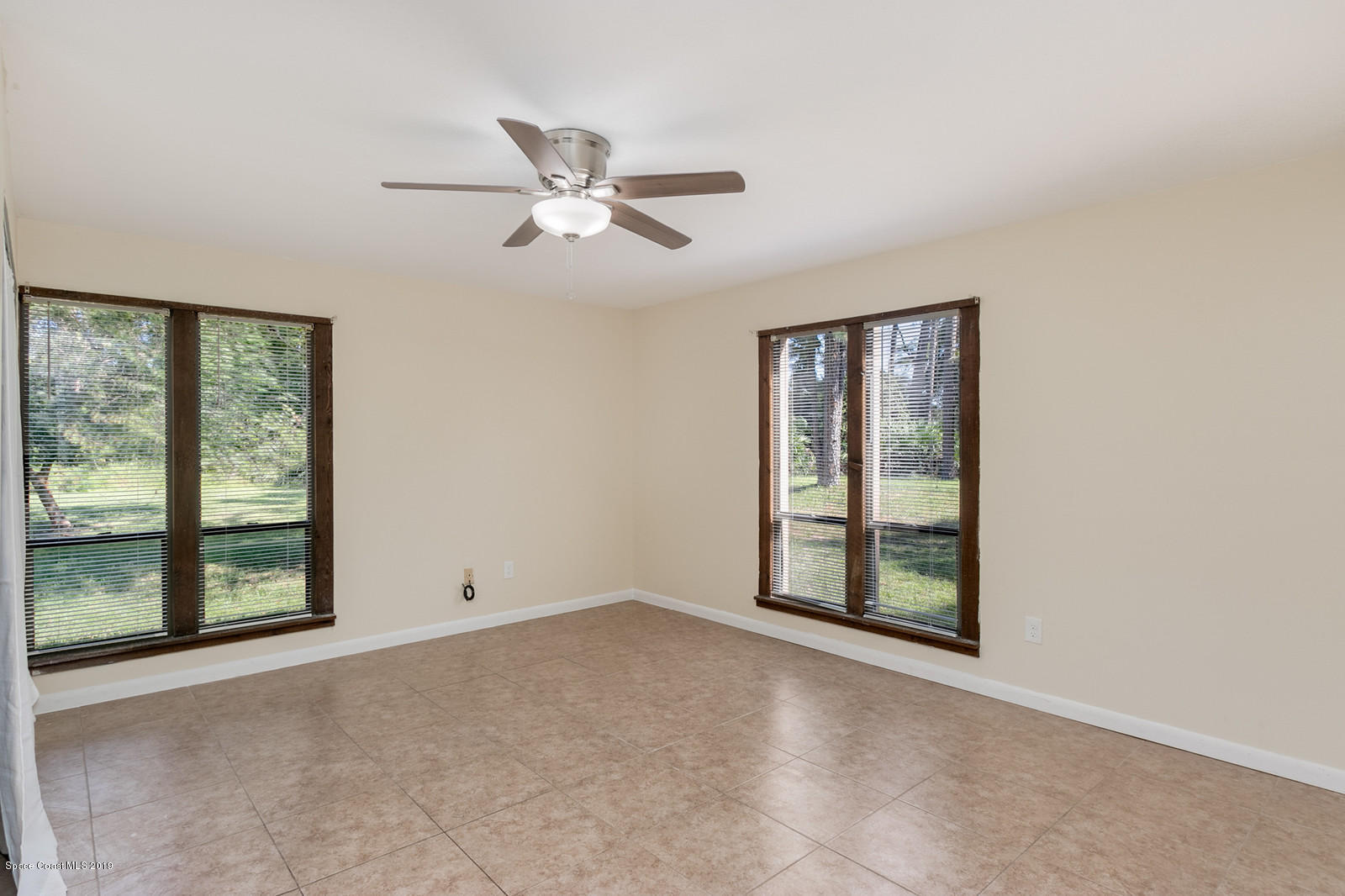 1695 Emmaus Road Northwest Palm Bay, FL 32907 - Photo 6 of 30 a view of an empty room with a window
