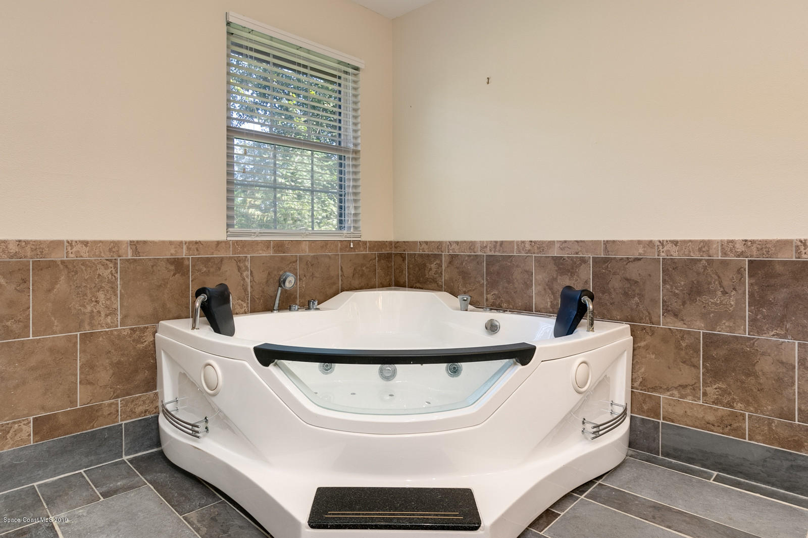1695 Emmaus Road Northwest Palm Bay, FL 32907 - Photo 8 of 30 a bathroom with a sink a toilet and a mirror